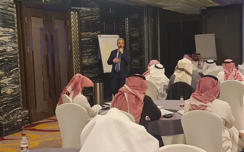 A Napica facilitator leading an executive leadership program session in Riyadh